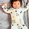 baby, infant, child, onesie, cute, smiling, face, hair, cushion, teddy_bear, soft, lying_down, indoors, happy, portrait, baby_clothes, small_feet, cozy, sleepwear, resting