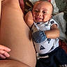 Kirk joined the competition — help win amazing prizes! baby, infant, smile, face, onesie, mittens, blanket, pattern, skin, belly_button, piercing, hand, arm, person, lying_down, comfort, cute, closeup, indoor, happy