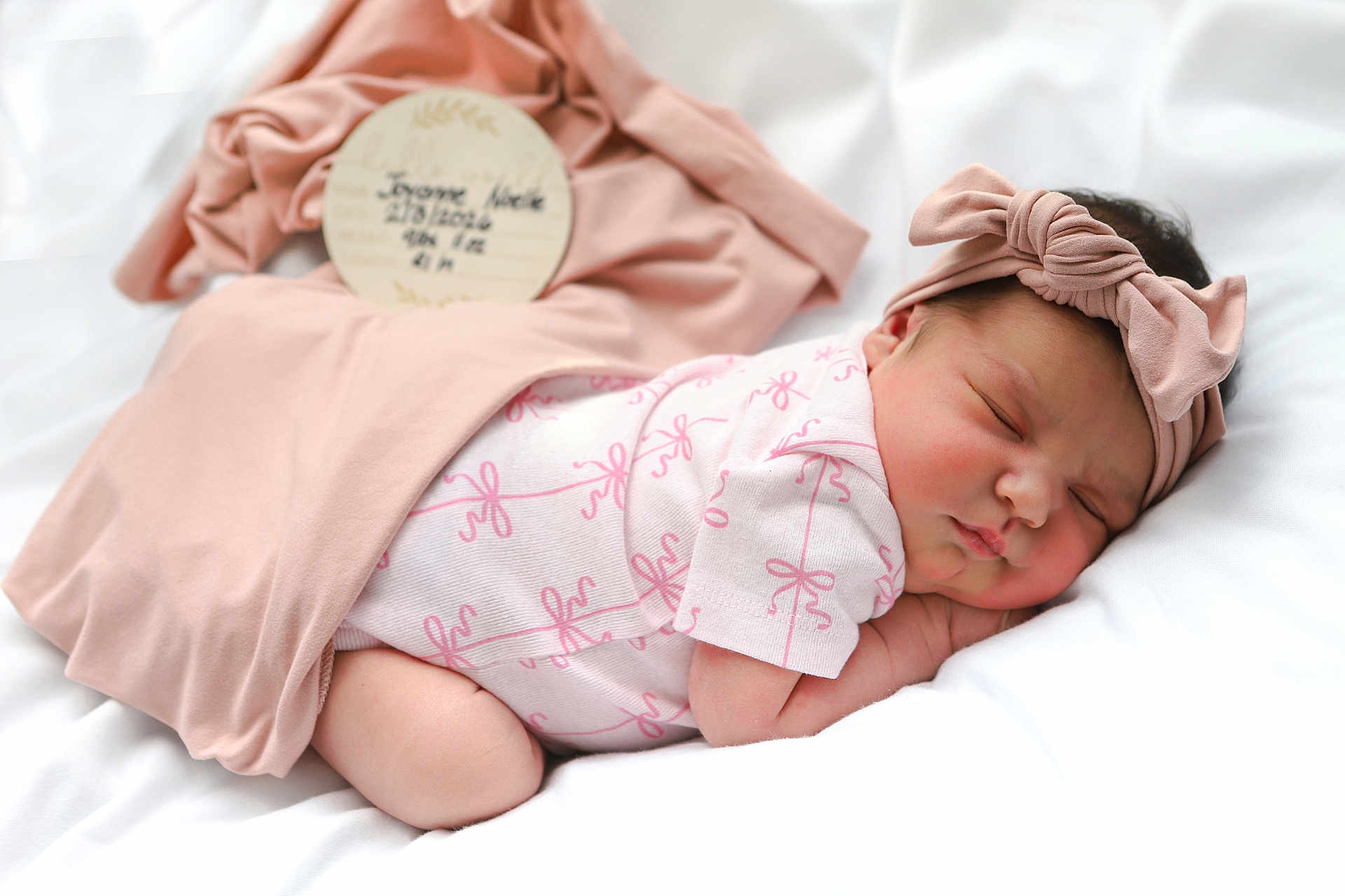 Joyanne Noelle joined the competition — help win amazing prizes! baby, blanket, child, clothing, cute, face, headband, indoors, infant, newborn, peaceful, pink, plush, portrait, rest, sleeping, soft, toddler, white, wrapped