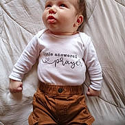Jason joined the competition — help win amazing prizes! baby, infant, child, white_shirt, brown_pants, lying_down, blanket, cute, expression, face, hands, clothing, soft_light, indoors, portrait, young_child, skin, head, eyes, mouth