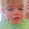 Riley is registered to the contest to win money with this photo: toddler, child, baby, portrait, face, close_up, blond_hair, blue_eyes, sleepy, serious_expression, green_shirt, colorful_clothing, palm_tree, indoor, adult, background, photography, head, person, family