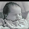 Tracie is registered to the contest to win money with this photo: baby, newborn, sleeping, infant, child, blanket, cozy, peaceful, portrait, soft_focus, cute, face, head, resting, young, indoors, clothing, closeup, calm, serene