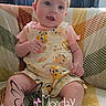 Tracie is registered to the contest to win money with this photo: baby, child, infant, headband, sitting, blanket, pattern, curtains, indoors, cute, smiling, clothing, socks, portrait, happy, person, face, expression, text_overlay, butterfly