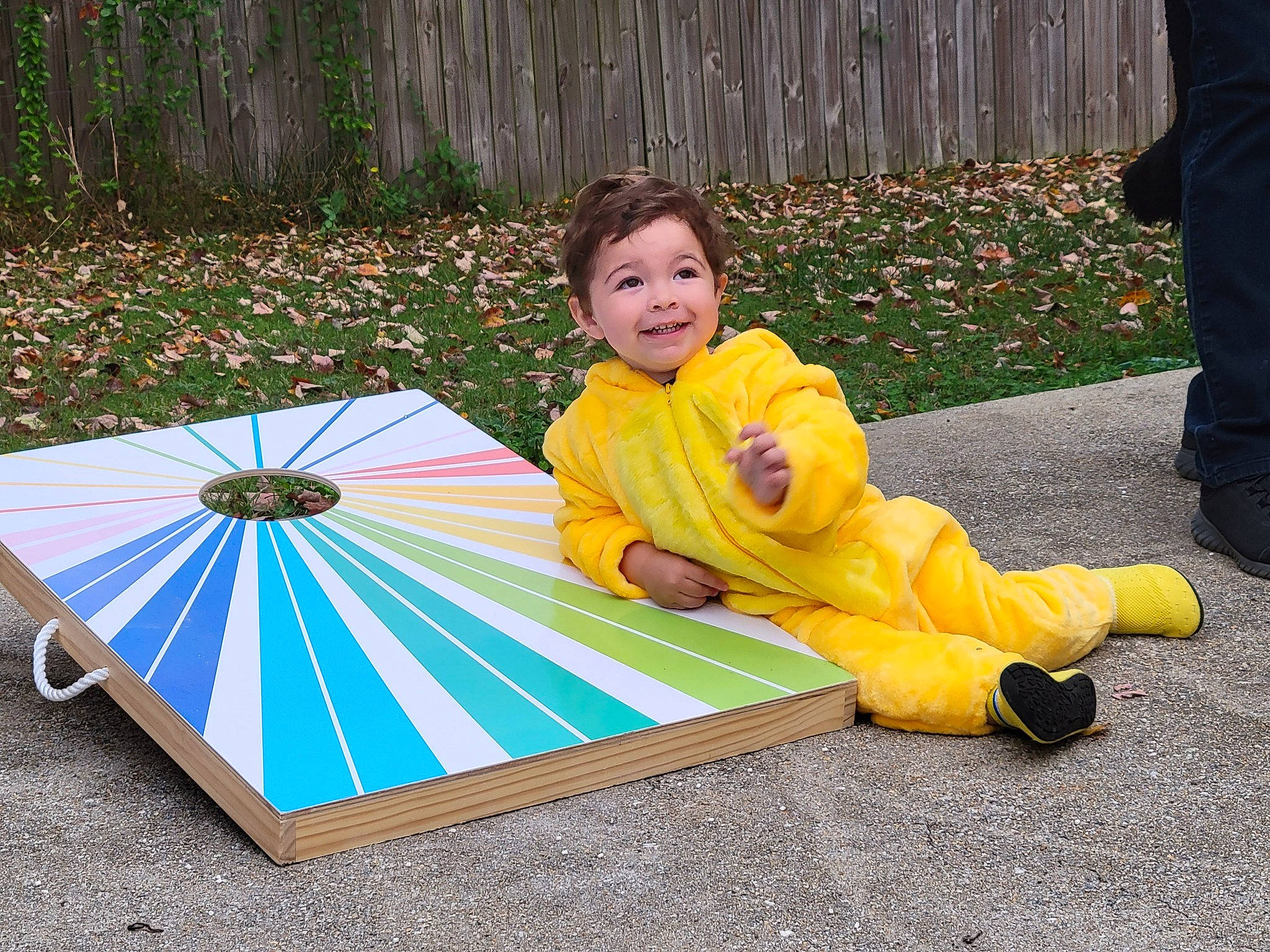 Anthony is registered to the contest to win money with this photo: asphalt, baby, baby_toddler_clothing, child, fun, games, grass, indoor_games_and_sports, joy, leisure, pattern, person, plant, play, recreation, road_surface, smile, symmetry, table, toddler