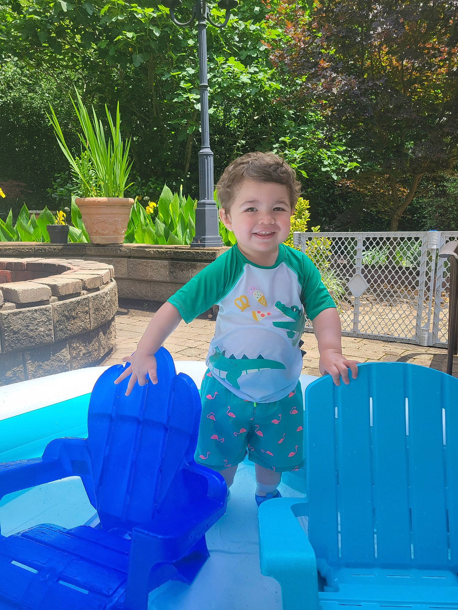 Anthony joined the competition — help win amazing prizes! baby_toddler_clothing, electric_blue, flowerpot, fun, grass, happy, houseplant, joy, leisure, outdoor_furniture, outdoor_play_equipment, person, plant, recreation, shorts, sitting, smile, t_shirt, toddler, tree