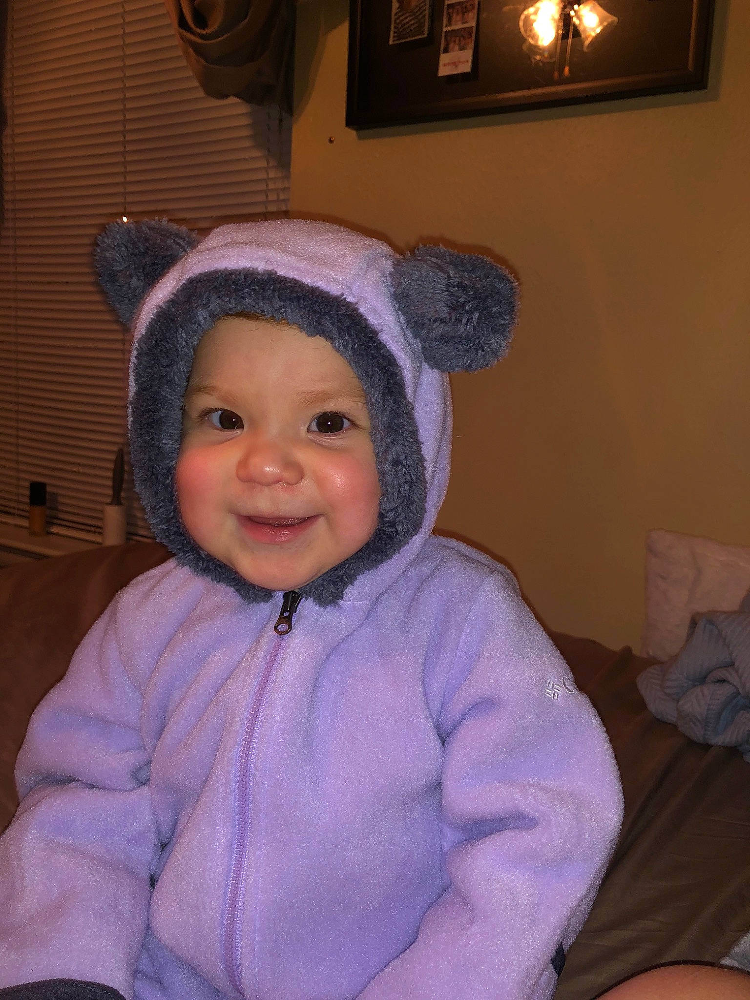 Lexie is registered to the contest to win money with this photo: baby, cheek, child, ear, eye, hat, head, headgear, headwear, joy, organ, outerwear, person, purple, skin, smile, toddler