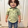toddler, child, curly_hair, smiling, standing, indoor, shirt, jeans, footwear, door, carpet, button_up_shirt, happy, person, cute, young_child, casual_clothing, full_body, portrait, home