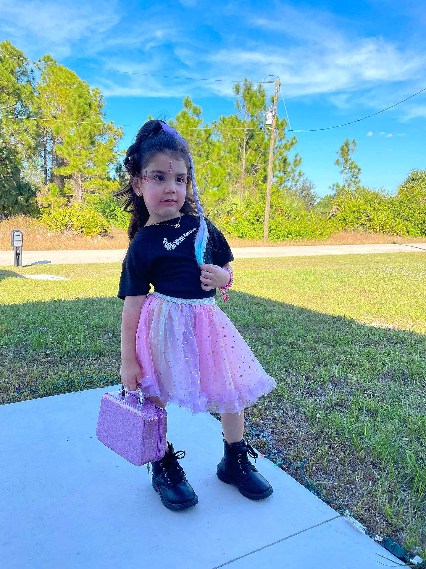 Mel joined the competition — help win amazing prizes! child, girl, outdoor, grass, skirt, boots, handbag, fashion, blue_sky, trees, sidewalk, accessories, young, pose, sunlight, nature, casual, happy, portrait, daytime