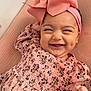 Mel joined the competition — help win amazing prizes! baby, child, smile, pink_bow, headband, floral_dress, dimple, happy, infant, cute, portrait, closeup, hand, pink, fabric, texture, indoors, person, face, joyful