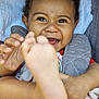 Gabriella a rejoint le concours — aidez-le/la à gagner de superbes lots ! baby, child, smiling, happy, face, foot, hand, cute, infant, close_up, skin, expression, joy, toddler, clothing, blanket, indoors, person, portrait, playful