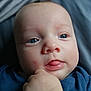 Gabriel participe au concours pour gagner de l'argent avec cette photo : baby, background_blur, blue_eyes, blue_shirt, child, close_up, clothing, curious, cute, expression, face, hand, indoor, infant, newborn, person, portrait, skin, soft_light, tongue