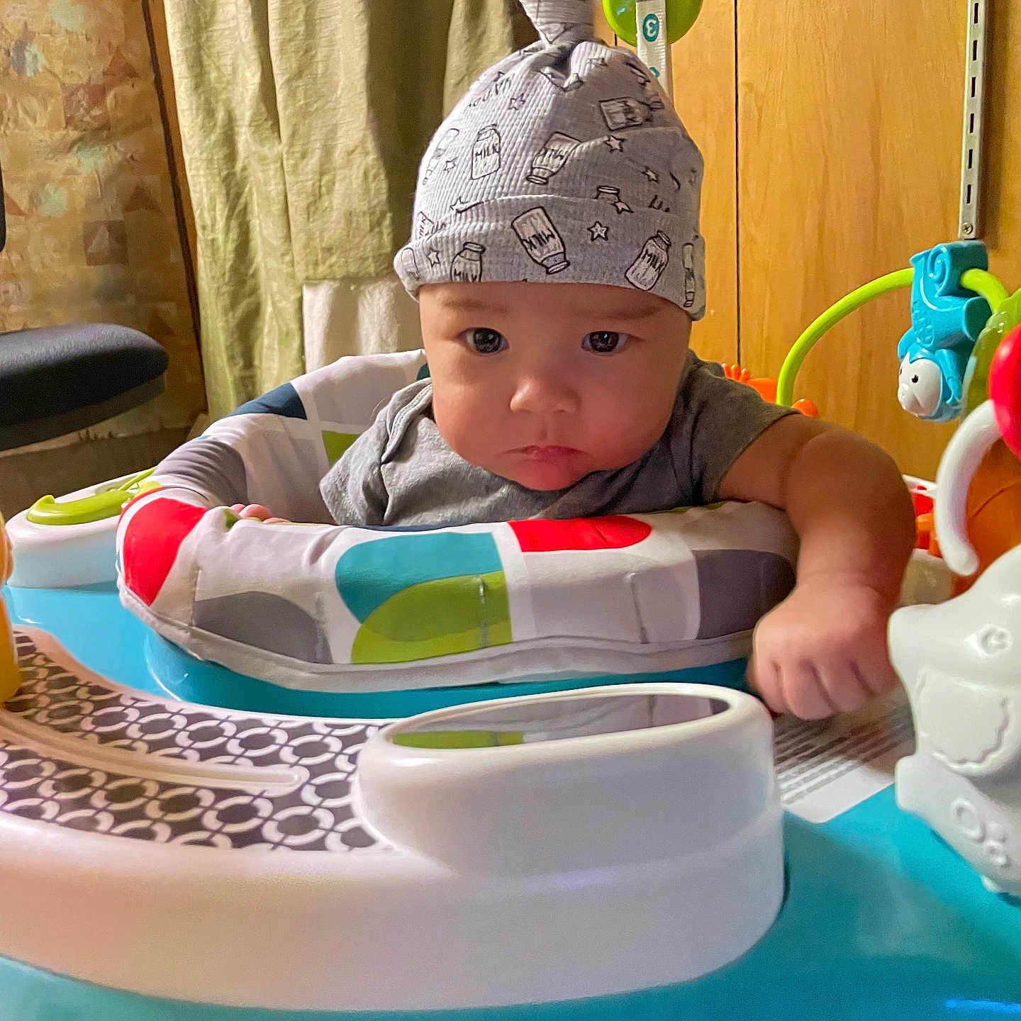 John Jr is registered to the contest to win money with this photo: baby, beanie, bodypart, bonnet, cap, clothing, couch, cutlery, face, furniture, hat, head, indoors, interiordesign, person, photography, portrait, sitting, spoon, swimwear