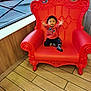 toddler, child, red_chair, indoor, window, wooden_wall, flooring, spiderman_sweater, socks, happy, smiling, reaching_hands, furniture, portrait, cute, small_child, casual_clothing, daylight, playful, seat