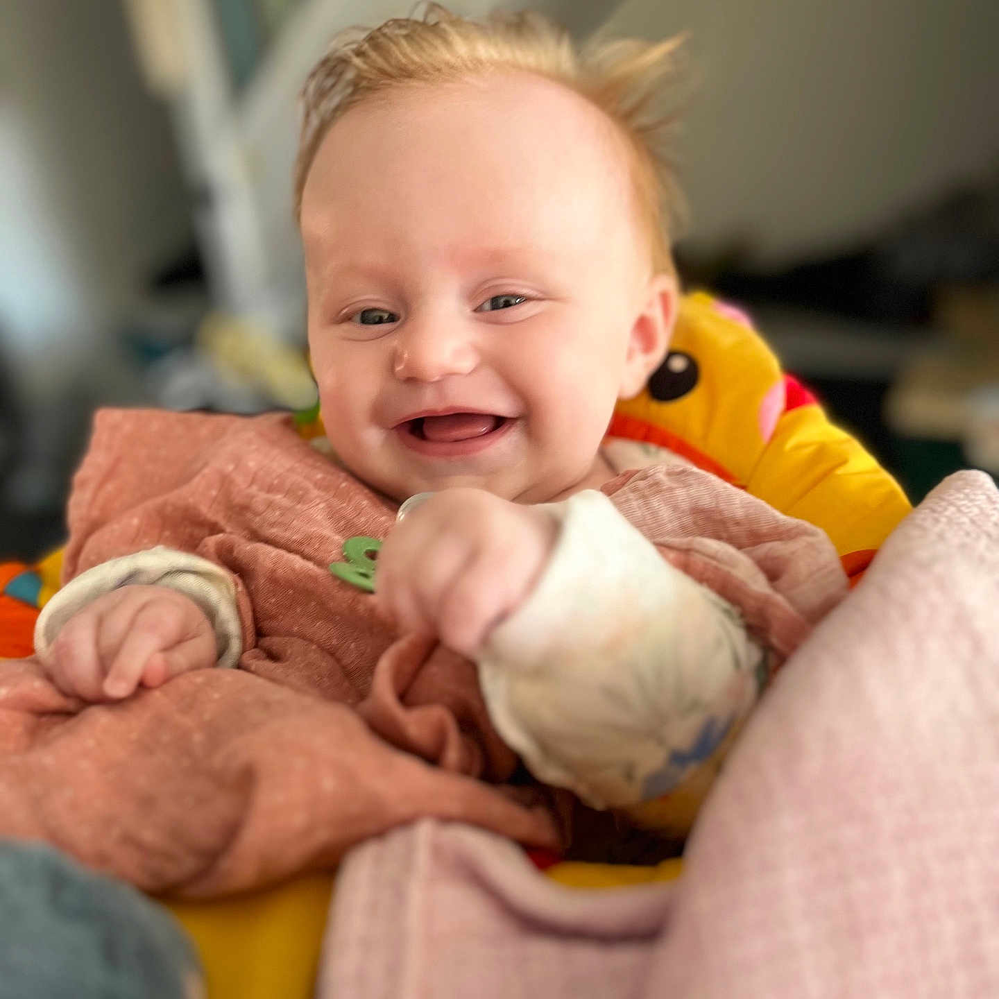 Eleanor is registered to the contest to win money with this photo: architecture, baby, babylaughing, blanket, blonde, bodypart, building, clothing, couch, cushion, face, finger, furniture, hair, hand, happy, head, homedecor, hospital, laughing