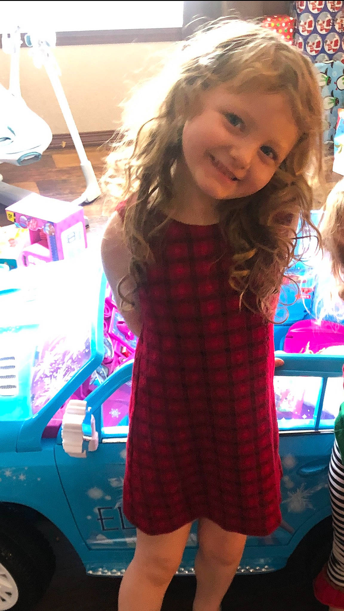 Skylee is registered to the contest to win money with this photo: alloy_wheel, blond, brown_hair, child_model, day_dress, dress, fender, hair, joy, long_hair, one_piece_garment, person, vehicle_door