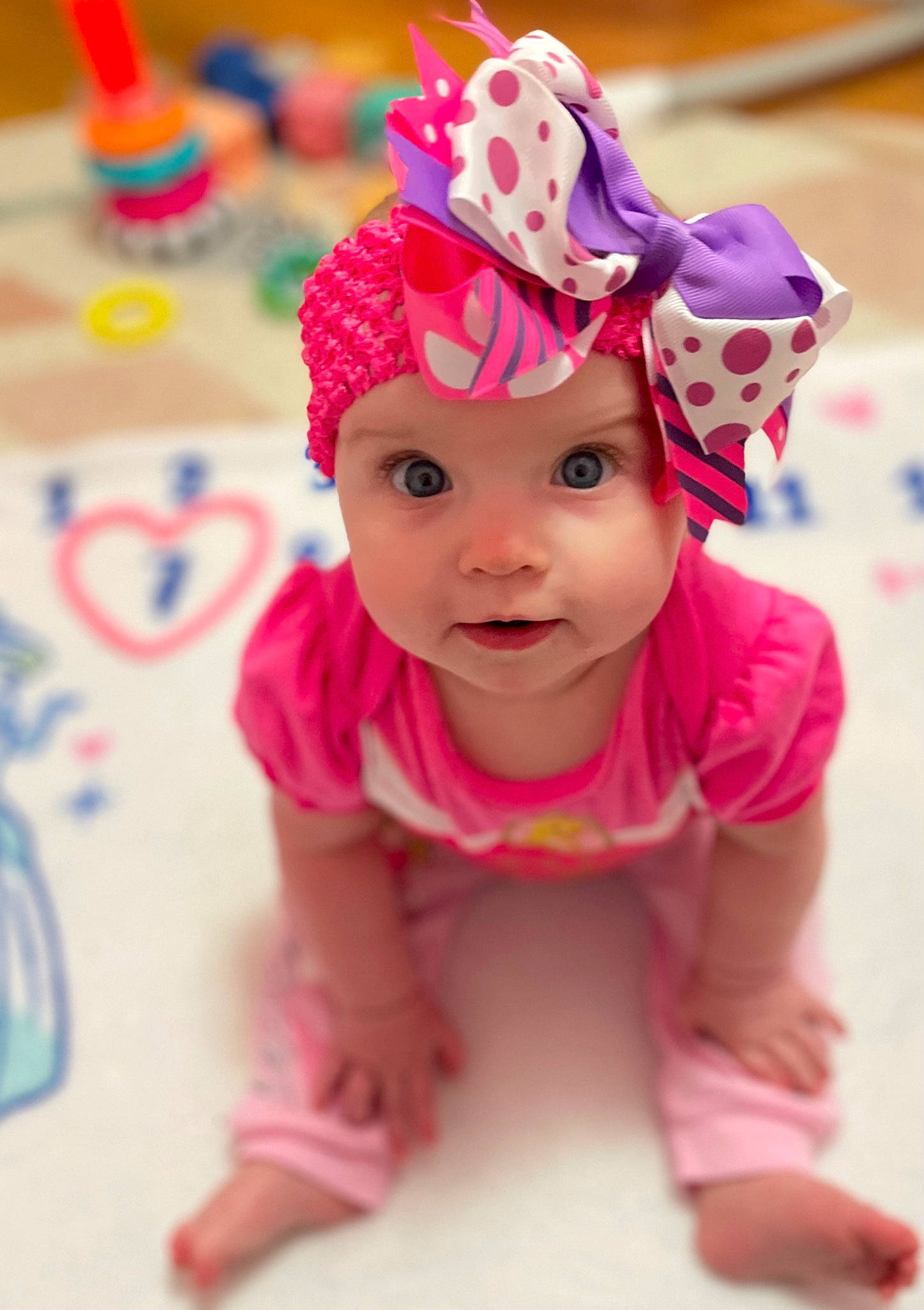 Delaney joined the competition — help win amazing prizes! baby, baby_toddler_clothing, cap, child, clothing, costume_hat, face, fun, happy, head, headpiece, headwear, helmet, magenta, party_supply, person, pink, product, sleeve, smile