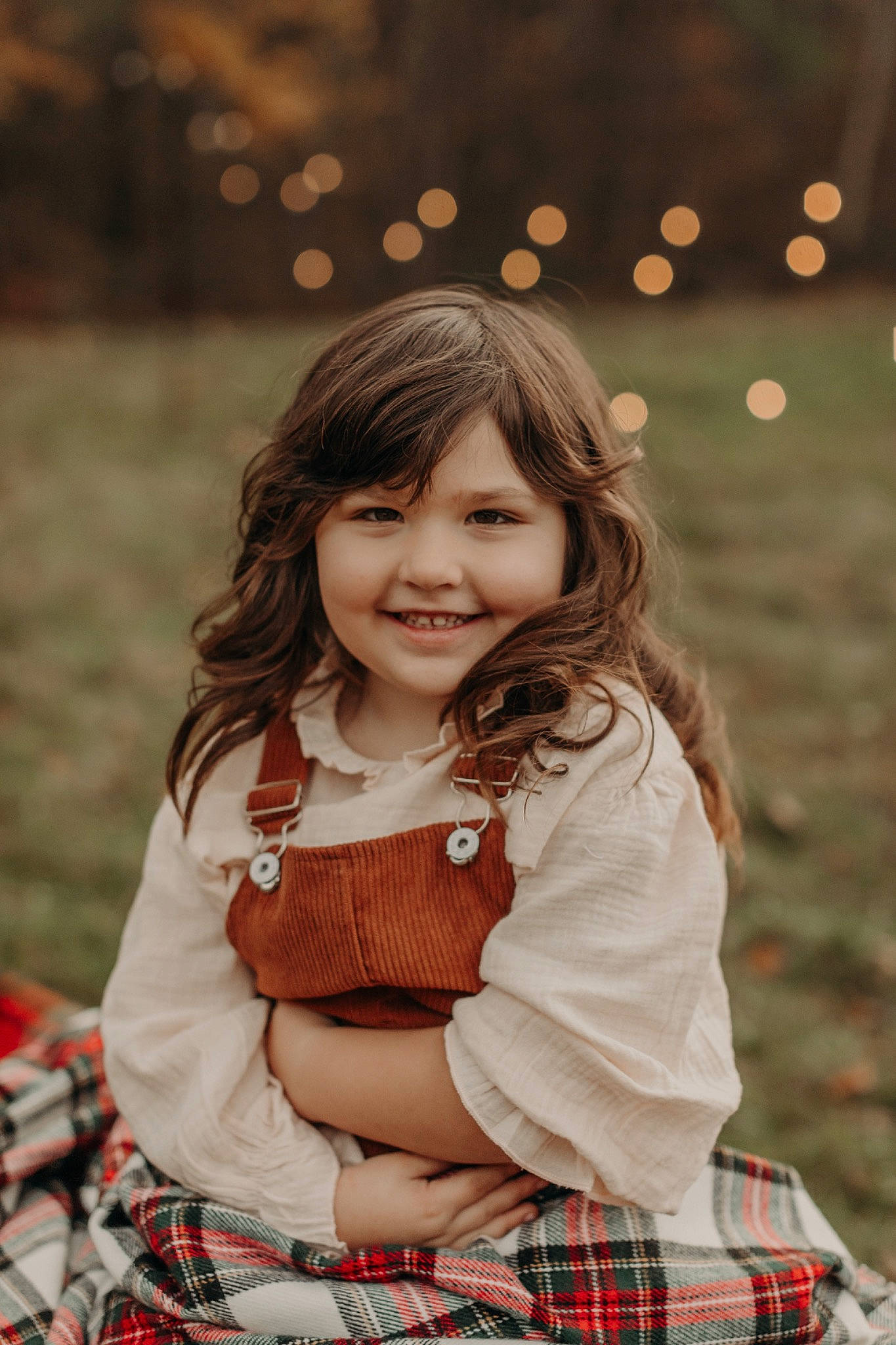 Charlotte is registered to the contest to win money with this photo: beauty, child, clothing, facial_expression, flash_photography, fun, grass, happy, joy, long_hair, pattern, people_in_nature, person, plaid, plant, skin, sleeve, smile, tartan, textile