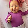 Romi-Dalton is registered to the contest to win money with this photo: apparel, baby, child, closeup, cute, expression, face, hand, happy, headband, indoors, infant, lying_down, person, play_mat, purple_clothing, skin, smiling, stars, toddler