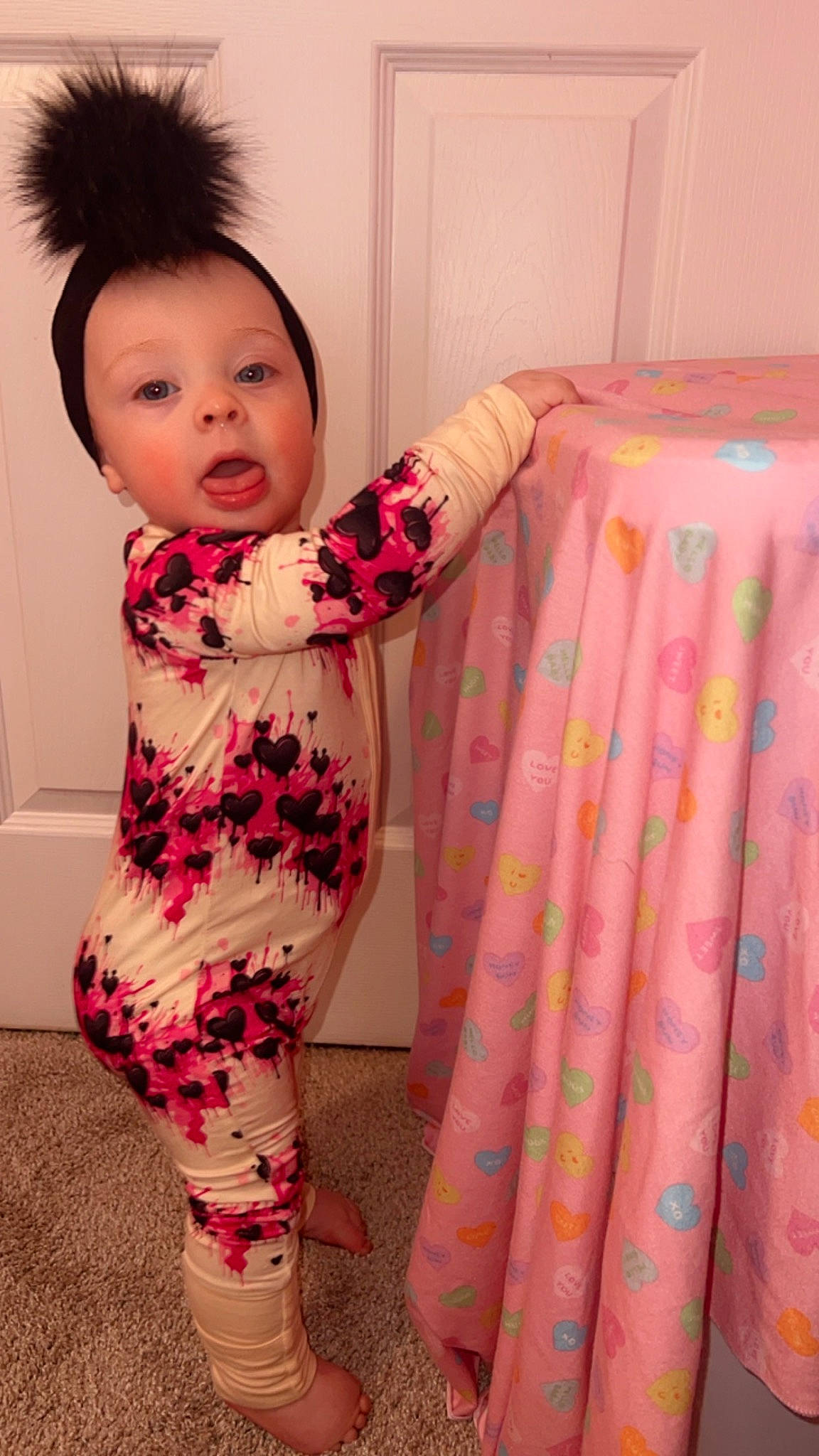 Raelynn is registered to the contest to win money with this photo: arm, baby, baby_toddler_clothing, finger, happy, human_body, joint, knee, leg, lip, magenta, neck, pattern, person, pink, shoulder, skin, sleeve, surprise, textile