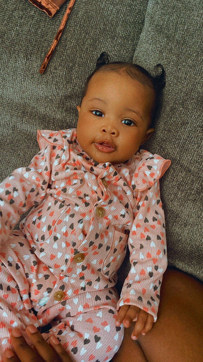 Khloé Chanel is registered to the contest to win money with this photo: baby, baby_toddler_clothing, cheek, child, collar, comfort, head, linens, lip, nose, orange, pattern, person, room, sitting, skin, sleeve, textile, toddler, toy
