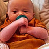 Paisley joined the competition — help win amazing prizes! baby, blanket, child, closeup, comfort, cozy, cute, face, hands, indoors, infant, orange_clothing, pacifier, person, portrait, resting, skin, soft_texture, toddler, young