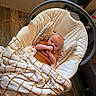 Paisley is registered to the contest to win money with this photo: baby, baby_rocker, blanket, blanket_pattern, child, clothing, comfort, cozy, cushion, furniture, home, indoor, infant, pacifier, person, relaxing, resting, soft_toys, wood_floor, young_child