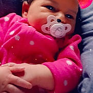 Luna is registered to the contest to win money with this photo: baby, infant, pacifier, pink_clothing, polka_dot, face, hands, lying_down, sparkles, filter, bear_ears, cute, child, indoors, soft_toys, blanket, cozy, portrait, smiling, young_child