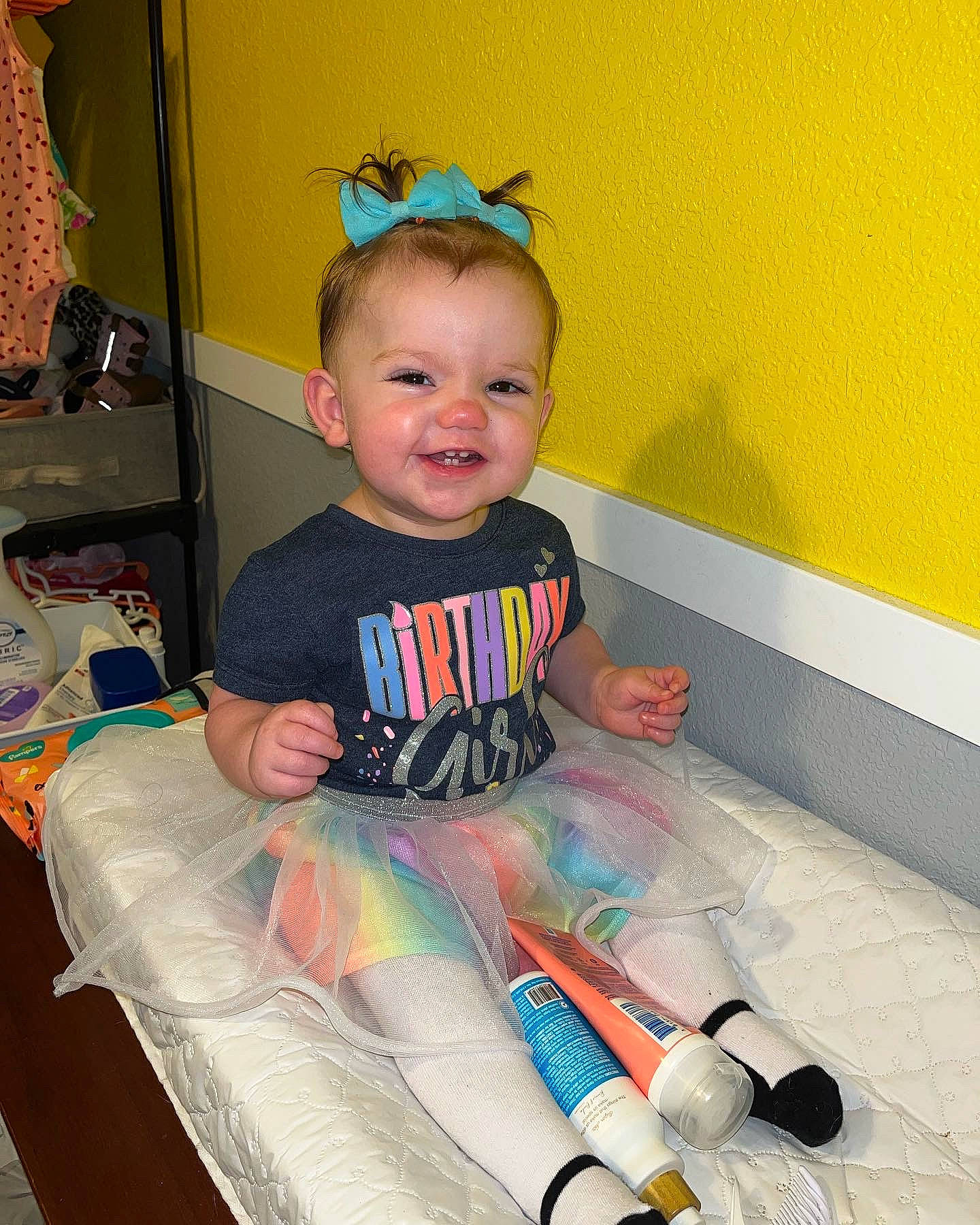 Helena is registered to the contest to win money with this photo: baby, baby_toddler_clothing, carmine, child, comfort, flooring, foot, fun, happy, human_leg, joy, knee, person, room, sitting, sleeve, smile, sock, standing, t_shirt