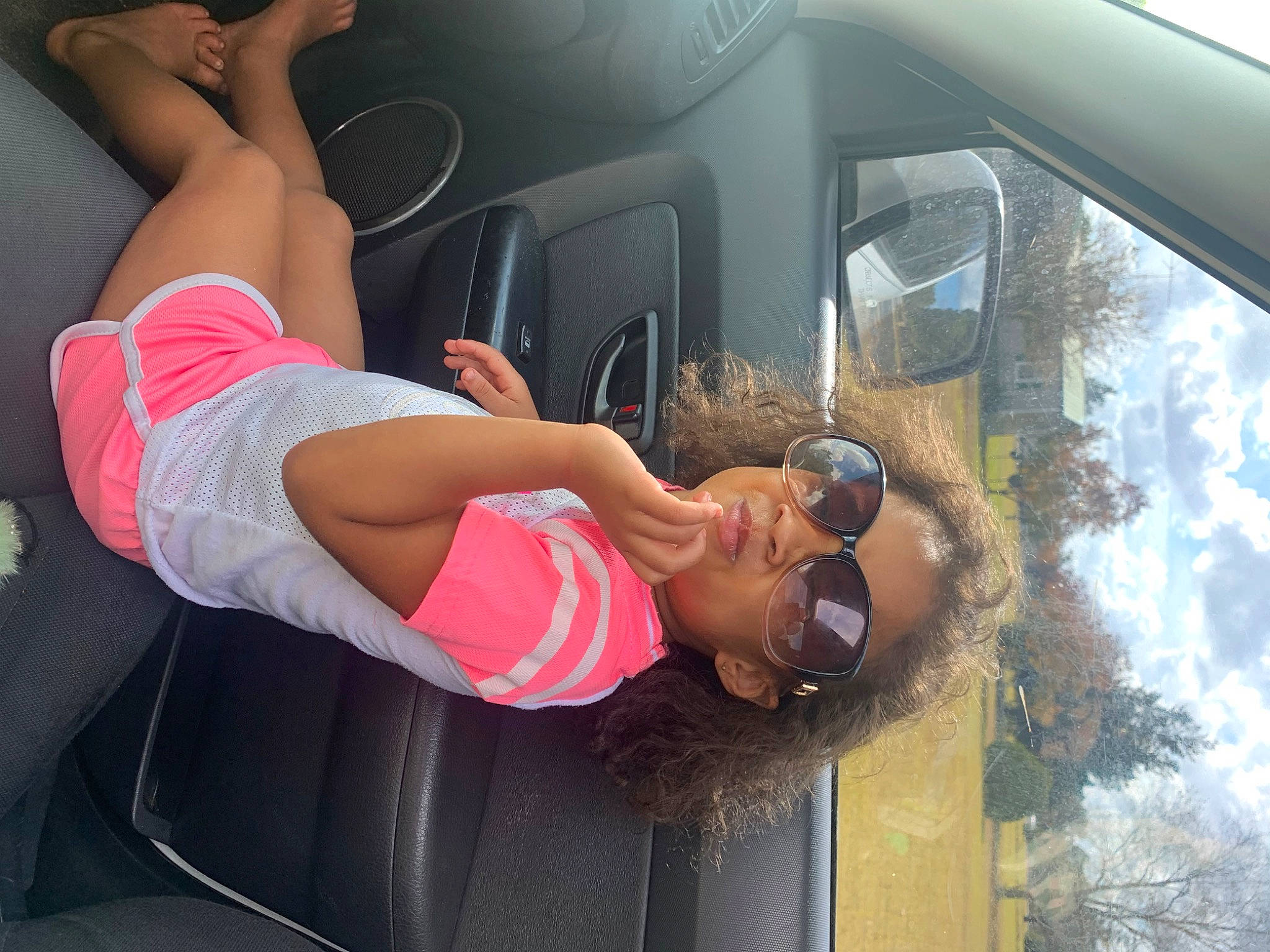 Airabella is registered to the contest to win money with this photo: automotive_design, automotive_exterior, car, chest, elbow, eyewear, fun, gesture, goggles, hat, human_leg, knee, leisure, motor_vehicle, muscle, person, shorts, sunglasses, thigh, vehicle
