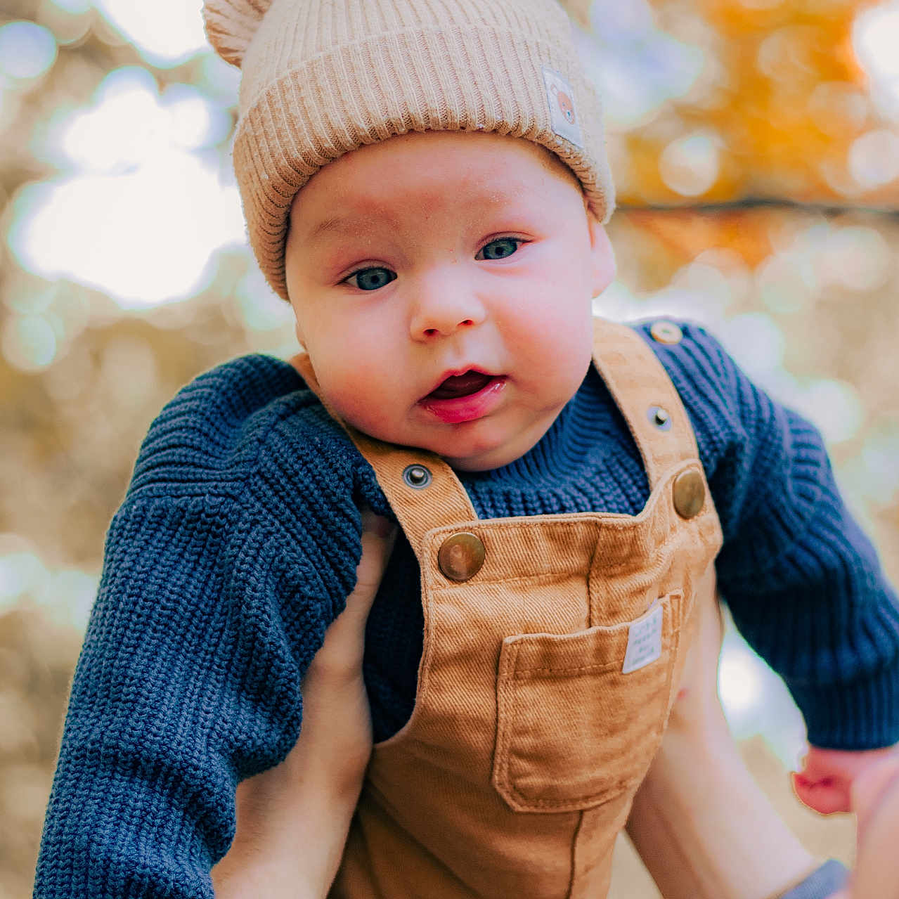 Harrison is registered to the contest to win money with this photo: baby, beanie, bodypart, bonnet, cap, clothing, face, finger, hand, happy, hat, head, jeans, knitwear, pants, person, photography, portrait, smile, sweater