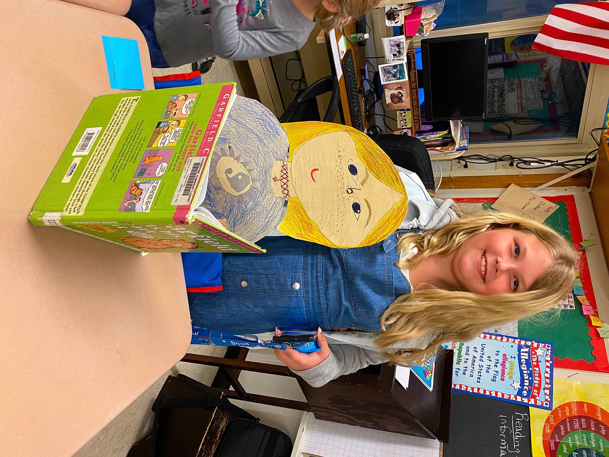 Braylynn is registered to the contest to win money with this photo: art, artist, book, child, flag, flag_of_the_united_states, fun, joy, person, publication, room, smile, t_shirt, textile, travel, visual_arts