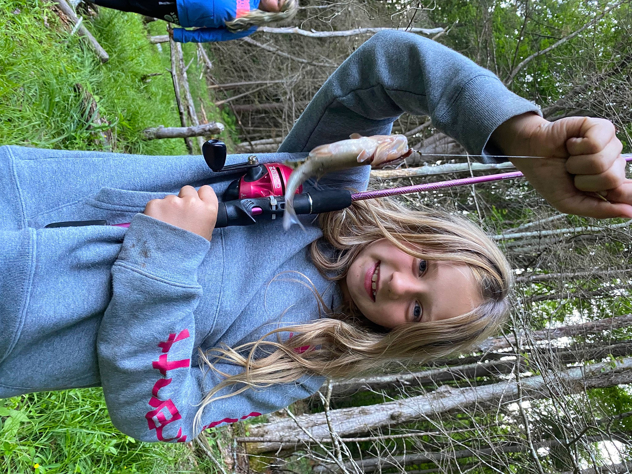 Amelia joined the competition — help win amazing prizes! clothing, fun, grass, happy, human_leg, joy, knee, leisure, people_in_nature, person, plant, recreation, sitting, smile, soil, thigh, tree