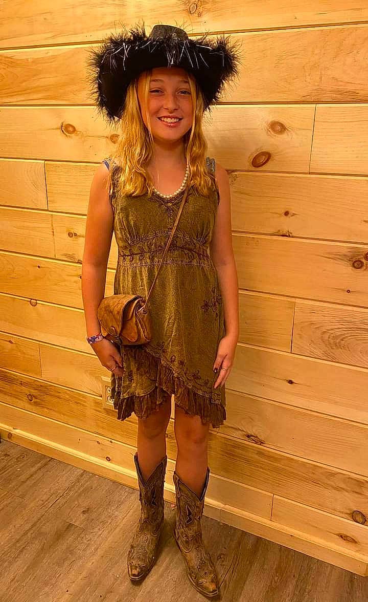 Emmalina is registered to the contest to win money with this photo: day_dress, dress, face, fashion_design, fawn, flooring, happy, hat, head, headwear, helmet, human_leg, joy, knee, leg, outerwear, person, shoe, sleeve, smile