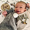 Waylon is registered to the contest to win money with this photo: baby, infant, smile, stuffed_animal, blanket, duck_pattern, onesie, clothing, cute, child, soft_toy, lying_down, happy, portrait, young_child, baby_boy, indoors, head, hand, two_months