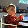 toddler, child, high_chair, food, kitchen, window, sunlight, smile, face, person, brown_clothing, table, chair, indoor, happy, cute, young_child, expression, home, daylight