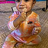 toddler, child, infant, baby, sitting, food, messy, face, hands, nike, onesie, colorful_clothing, indoor, rug, toy, playtime, expression, cute, curious, young_child