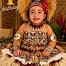 child, toddler, birthday, celebration, traditional_clothing, headdress, shell_jewelry, smiling, portrait, sitting, tropical, decorative, festive, costume, cultural, happy, one_year_old, plumeria_flower, grass_skirt, cute