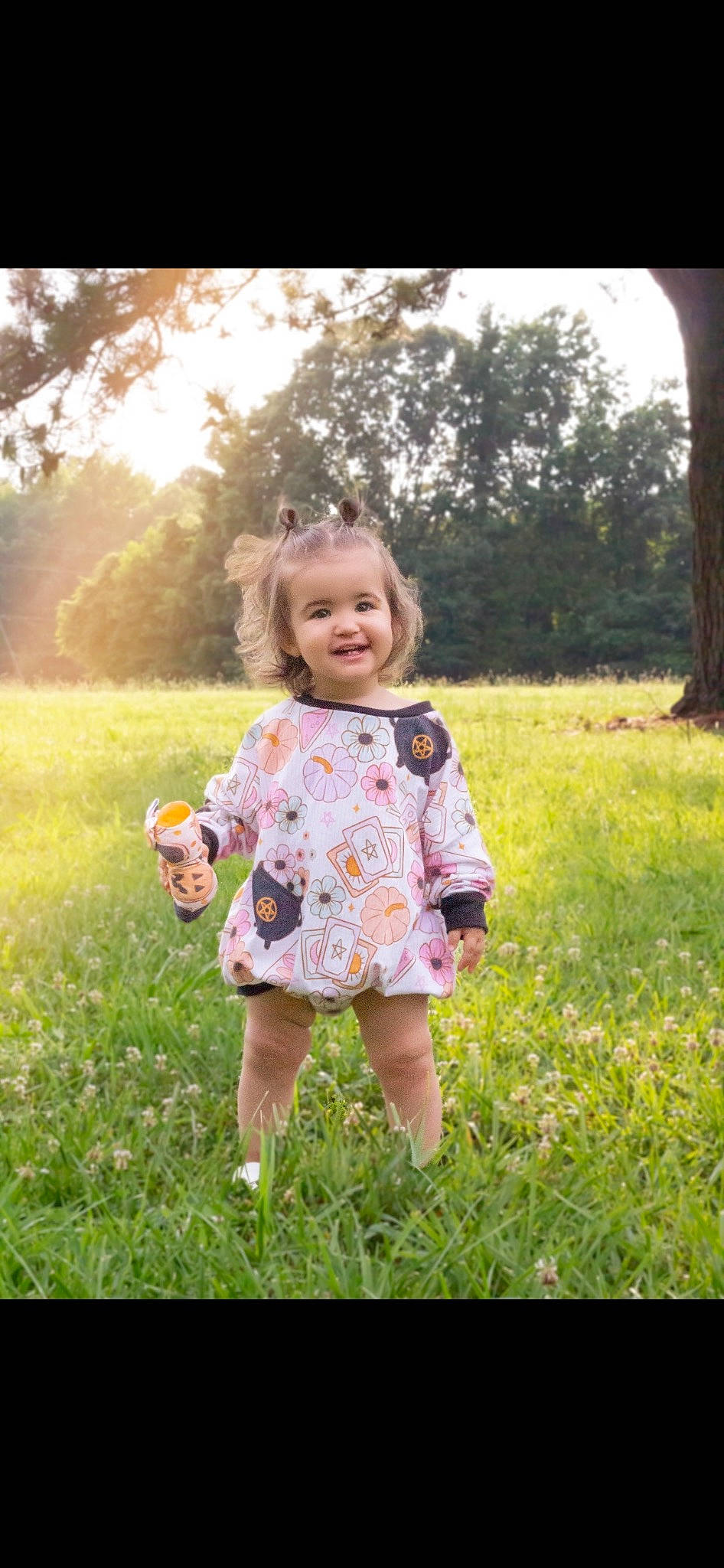 Eleanor is registered to the contest to win money with this photo: baby_toddler_clothing, blond, child, flash_photography, fun, grass, grassland, green, happy, joy, leaf, meadow, pattern, people_in_nature, person, plant, prairie, sky, smile, summer
