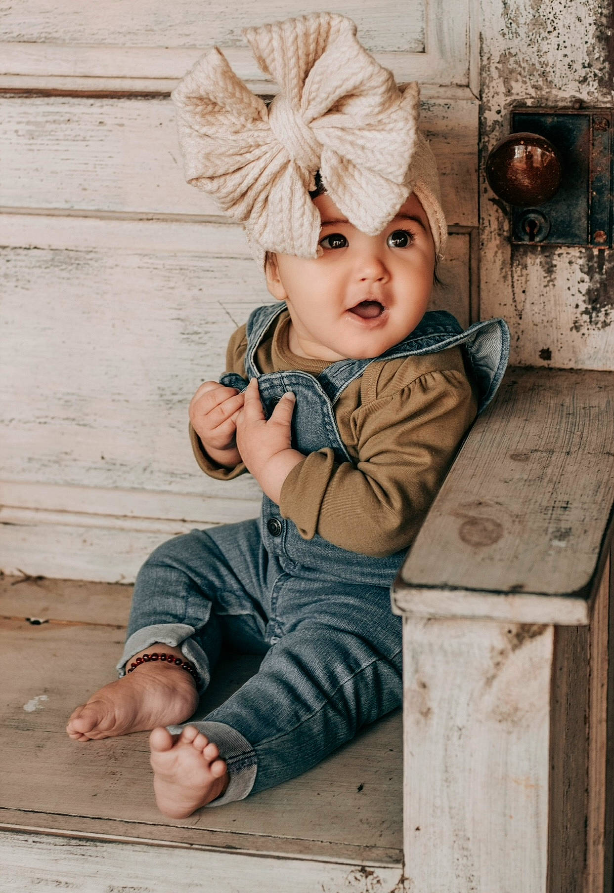 Eleanor is registered to the contest to win money with this photo: blond, cap, child, chin, eye, facial_expression, fashion_accessory, flooring, fur, happy, head, headpiece, headwear, pattern, person, sitting, surprise, toddler, vacation, vintage_clothing