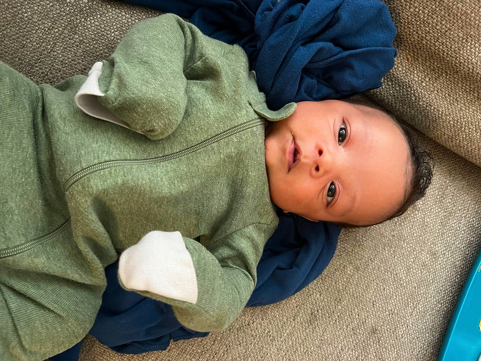 Louis is registered to the contest to win money with this photo: baby, baby_products, baby_toddler_clothing, blue, cheek, child, collar, comfort, electric_blue, grass, grey, linens, nose, person, sitting, skin, sleep, sleeve, toddler, tree