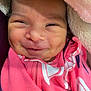 baby, smile, close_up, pink_blanket, dimples, face, infant, clothing, cute, newborn, wrapped, young_child, happy, skin, portrait, baby_face, soft_texture, warm, cozy, child