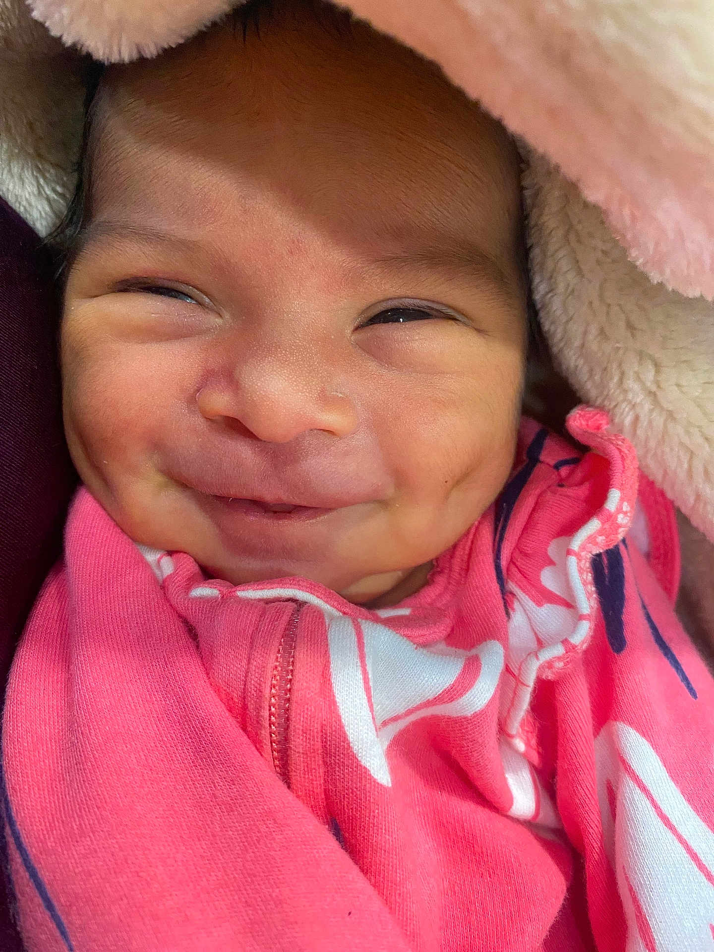 Aolany joined the competition — help win amazing prizes! baby, smile, close_up, pink_blanket, dimples, face, infant, clothing, cute, newborn, wrapped, young_child, happy, skin, portrait, baby_face, soft_texture, warm, cozy, child
