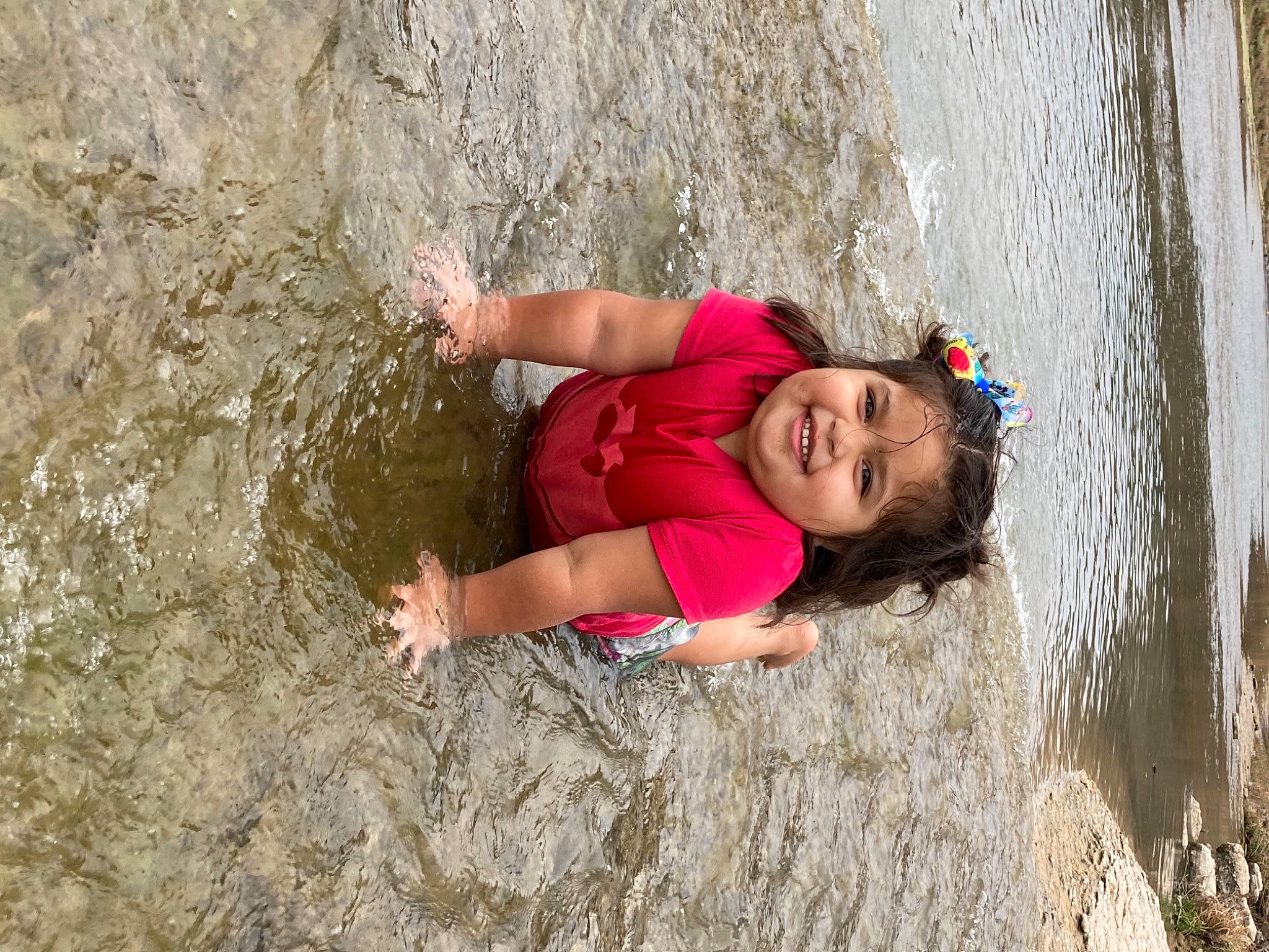 Janayle joined the competition — help win amazing prizes! bedrock, body_of_water, child, eye, formation, geological_phenomenon, grass, happy, joy, leg, leisure, outdoor_recreation, people_in_nature, person, recreation, skin, toddler, tree, trunk, water