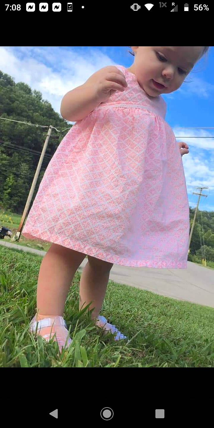 Aubri is registered to the contest to win money with this photo: baby, baby_toddler_clothing, day_dress, dress, foot, grass, headwear, lavender, one_piece_garment, pattern, person, pink, sandal, summer