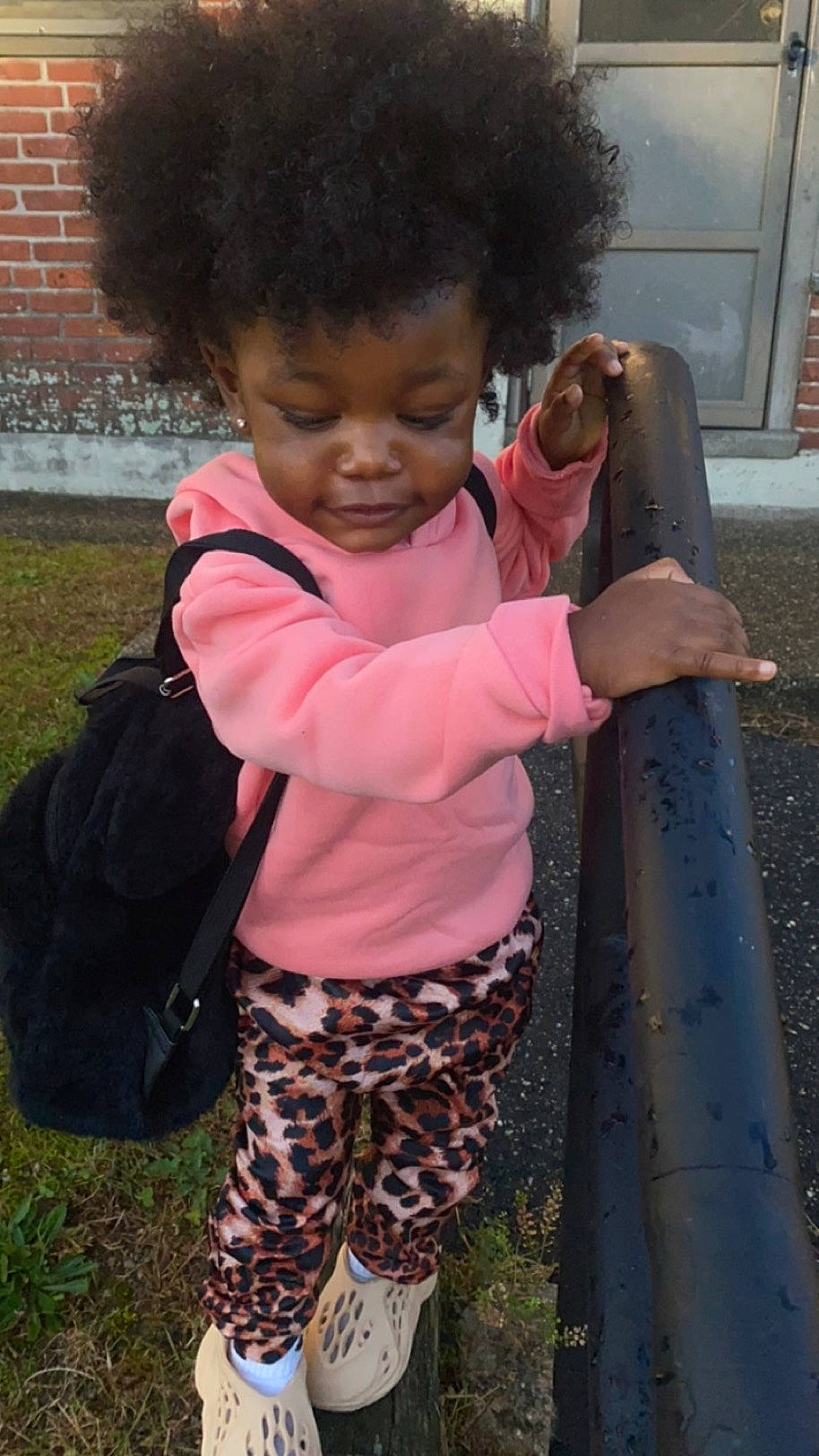 Alaiya joined the competition — help win amazing prizes! afro, baby, baby_toddler_clothing, brickwork, child, companion_dog, fun, grass, hair, happy, head, luggage_and_bags, magenta, nose, pattern, person, pink, sleeve, standing, thumb