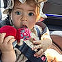 baby, child, car_seat, seatbelt, hat, plush_toy, chewing, sunlight, closeup, face, hand, clothing, infant, cute, indoors, person, headwear, sitting, expression, bright_eyes