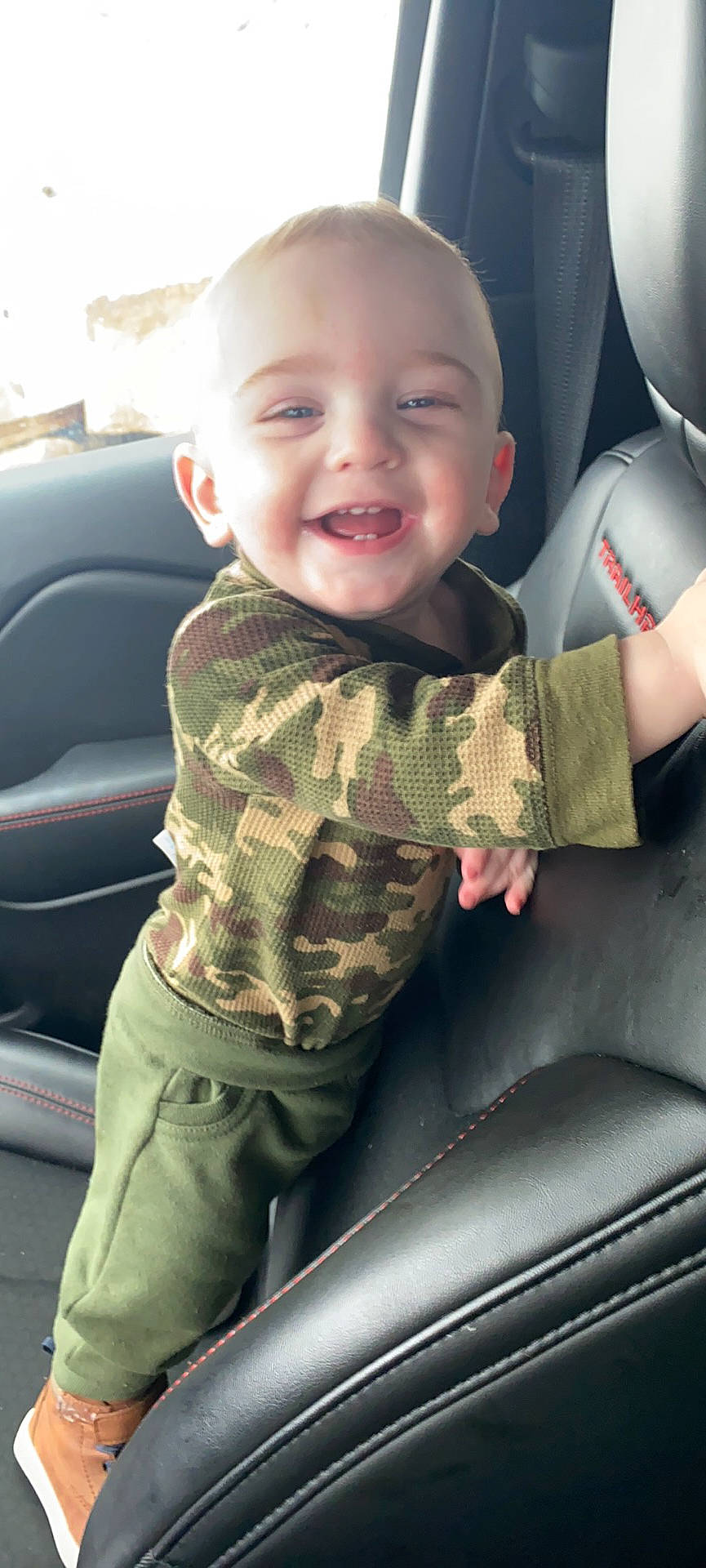 Gregory is registered to the contest to win money with this photo: auto_part, automotive_design, automotive_exterior, baby, baby_toddler_clothing, car, car_seat, cool, finger, head, joy, light, motor_vehicle, person, skin, sleeve, smile, toddler, vehicle, vehicle_door