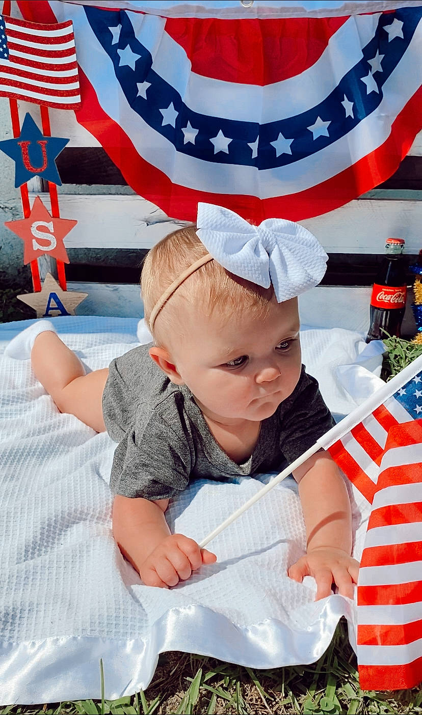 Nova joined the competition — help win amazing prizes! baby, baby_toddler_clothing, blue, carmine, child, costume_hat, event, fan, flag, flag_day_usa, flag_of_the_united_states, fun, gesture, happy, holiday, lap, person, recreation, red, toddler
