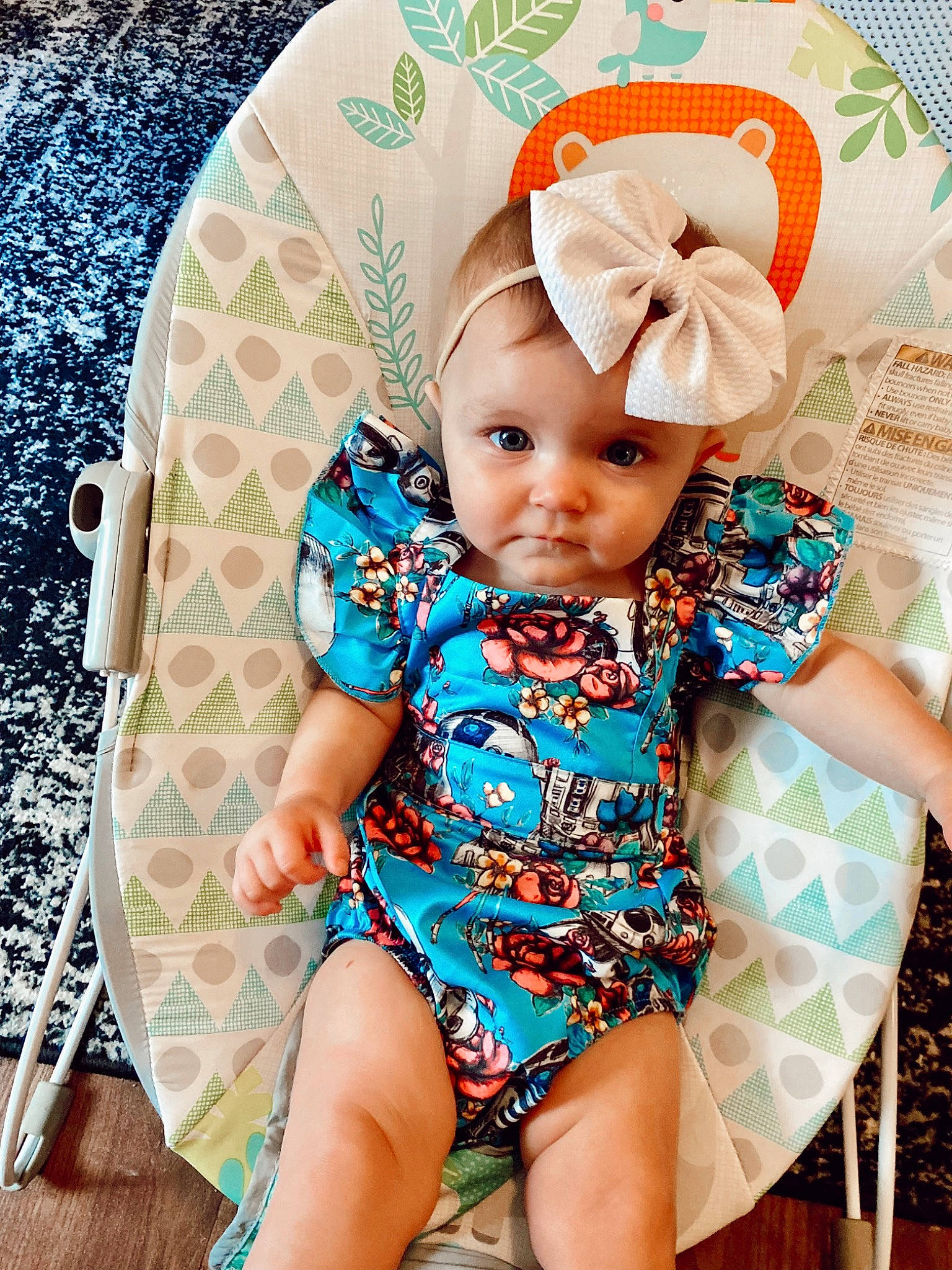 Nova is registered to the contest to win money with this photo: aqua, baby, baby_toddler_clothing, chair, child, comfort, cool, face, facial_expression, happy, head, headwear, human_leg, neck, pattern, person, pink, sitting, skin, sleeve