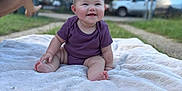 Desiree joined the competition — help win amazing prizes! baby, child, smiling, purple_onesie, headband, bow, blanket, outdoor, grass, garden, happy, sitting, infant, cute, face, parked_car, person, foot, skin, daylight
